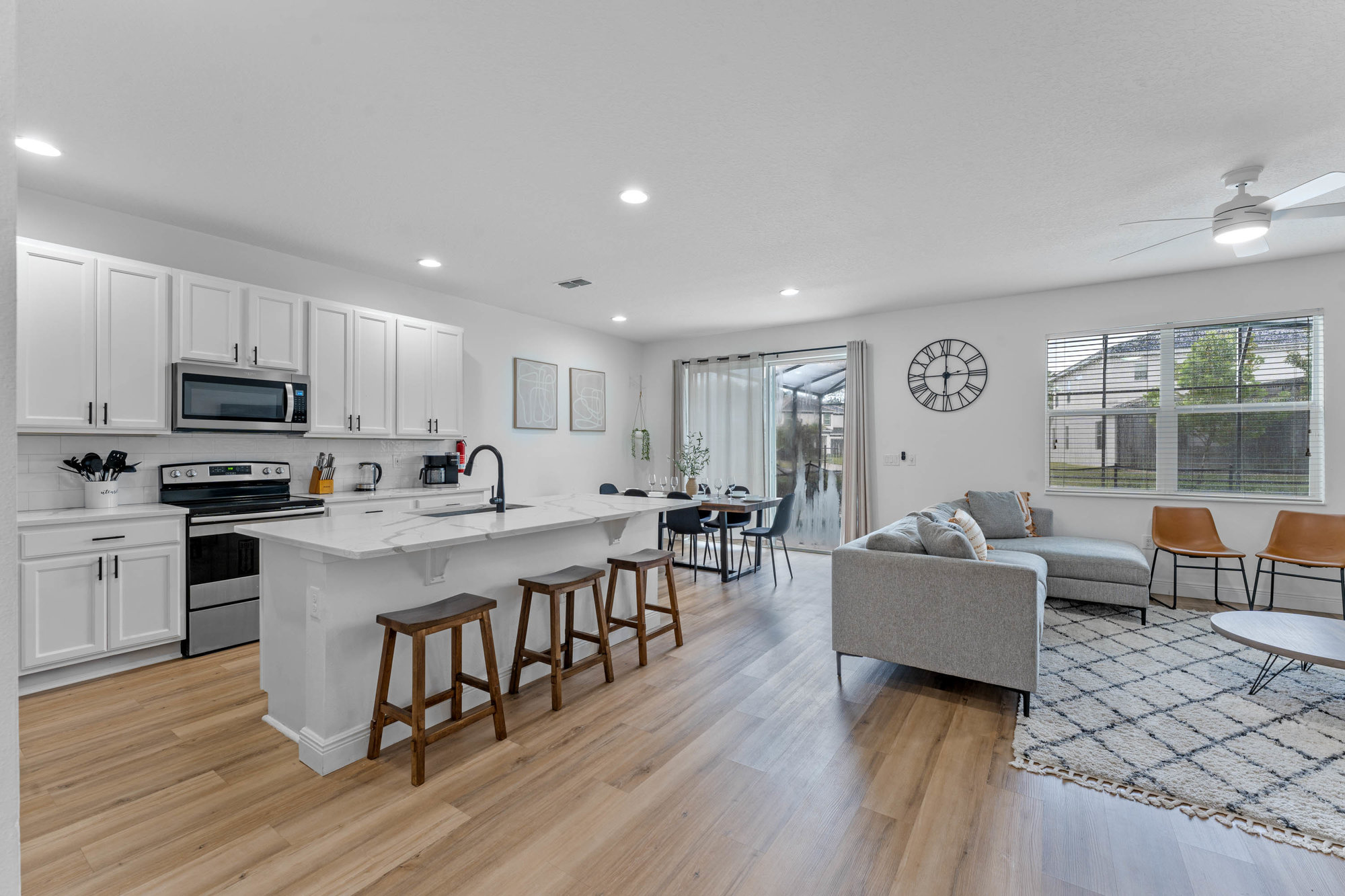 kitchen and living room with white cabinets and decor